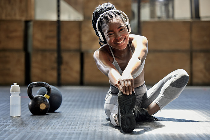 girl stretching looking at camera